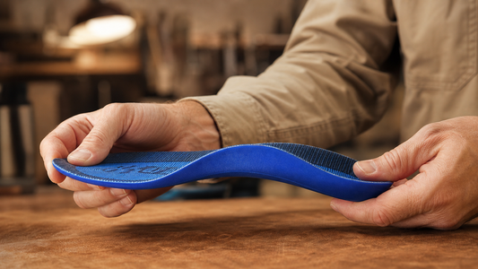 Hands gently flexing a shaped blue soft orthotic
